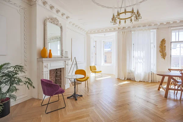 luxury interior of a spacious apartment in an old 19th century historical house with modern furniture. high ceiling and walls are decorated with stucco