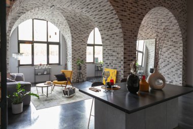 Ortaçağ şatosu tarzında parlak aksanlı, vahşi bir apartman dairesinin modern lüks tasarımı. Yemek pişirmek ya da zaman geçirmek için bir adası olan şık gri bir mutfak.
