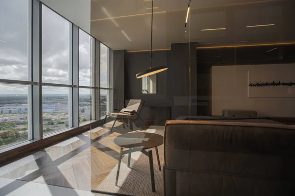 stock image cool expensive interior design of room in prestigious luxury hotel with dark tones with modern LED lighting and stylish furniture. the area with a sink is separated by dark glass from the bedroom