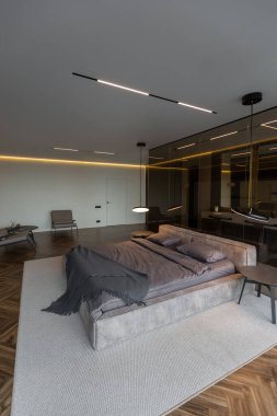 Modern LED ışıklandırmalı ve şık mobilyalı prestijli lüks otelin pahalı iç tasarımı. Lavabosu olan alan yatak odasından koyu camla ayrılmış.