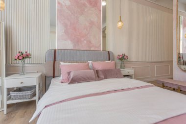Yatak odasının yakın görüntüsü modern, yumuşak bir iç mekan sıcak, hassas pastel, pembe ve bej renkler.