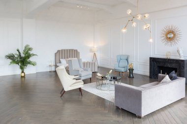 Pastel renklerde modern lüks daireler. Gün ışığıyla dolu kocaman pencereli çok parlak bir oda. Beyaz duvarlar, ahşap parke döşemeler ve koyu mermer bir şömine.