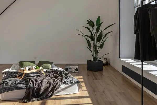 stock image minimalist stylish interior of white simple bedroom with window in ceiling and sun rays without people