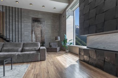 Süslü minimalist dizginlenmiş modern apartman dairesi, yüzme havuzlu geniş bir oda, dağlara bakan geniş panoramik pencereler. Gündüzleri insanlar olmadan