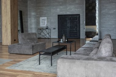 Süslü minimalist dizginlenmiş modern apartman dairesi, yüzme havuzlu geniş bir oda, dağlara bakan geniş panoramik pencereler. Gündüzleri insanlar olmadan