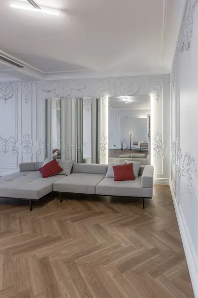 stock image interior of a spacious room with stylish modern furniture in an old luxury historical house with decorations and stucco on white walls