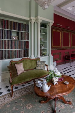 the chic expensive interior of the living room in the historical Baroque style, tiles on the floor, walls decorated with wood. the furniture is in a historical style. clipart