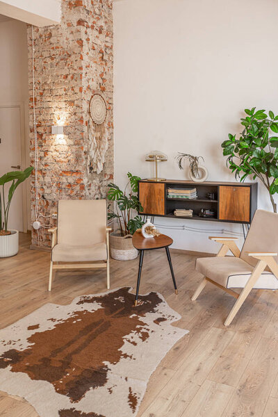 Bright and spacious living area featuring modern furniture and natural light in a stylish apartment in soft warm colors