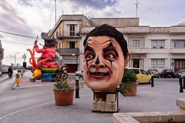 Giant papier-mache heads of carnival dolls decorate the streets during the carnival celebration: Zabbar, Malta - February 27, 2022