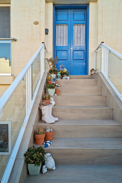 Bright boots filled with green sprouts highlight clever reuse of old shoes, shoes adding playful charm to porch, shoes uniting eco friendly mindset with whimsical yard appeal