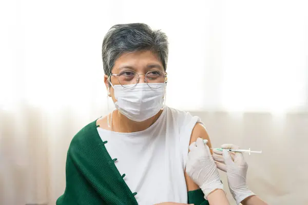 Senior Asian Woman Protective Mask Making Injection Hospital Royalty Free Stock Images
