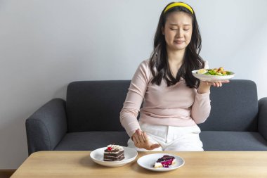 Mutfaktaki masada kahvaltı yapan bir kadın.