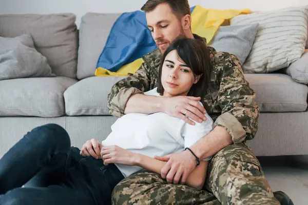 stock image Defending Ukraine. Soldier in uniform is at home with his wife.