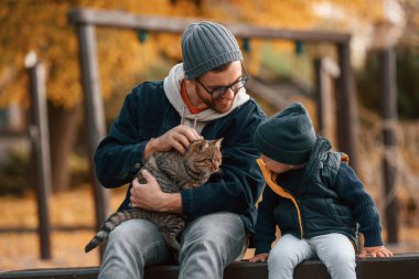 Kedi besliyorum. Baba ve küçük oğlu gündüz vakti dışarıda beraberler..