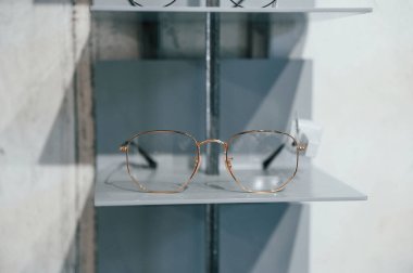 Close up view of glasses that is on the shelves indoors in the store. clipart