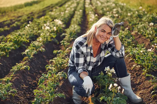 stock image Sitting and smiling. Woman is on the agricultural field at daytime.