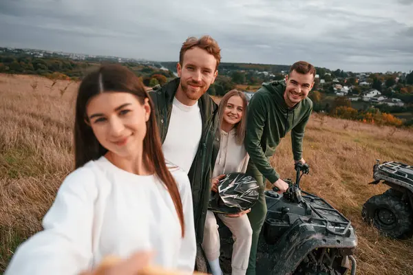 stock image Selfie type view. Two young couples with quad bikes is together on the field.