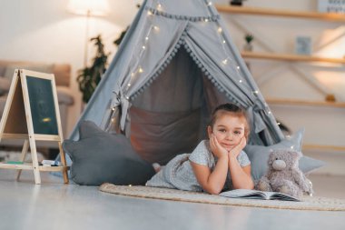 Yere yatıyorlardı. Evdeki çadırda oynayan sevimli küçük kız..