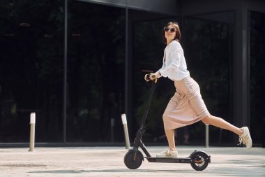 Güzel, genç bir bayan dışarıda motosikletiyle bekliyor..