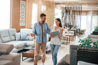 Ön manzara. Dükkandaki yatağı ve kanepeyi seçen çift..