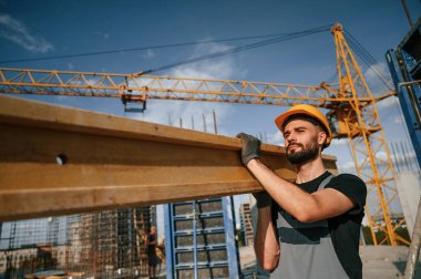 Üniformalı adam inşaat alanında çalışıyor..