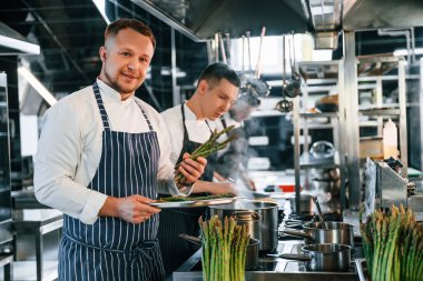 İşbirliği kavramı. Mutfak işçileri birlikte yemekleri hazırlıyorlar..