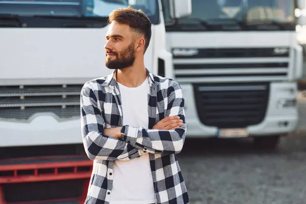 stock image Posing, standing with arms crossed. Young truck driver is with his vehicle at daytime.