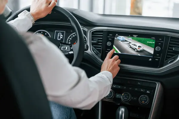 stock image Driving a car. Woman is in autosalon at daytime.