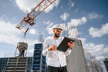 Evraklı not defteriyle. Foreman inşaat alanında çalışıyor..