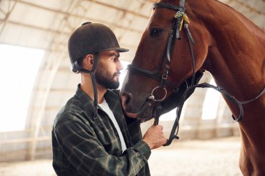 Hayvanlara bakıyorum. Atlı genç adam hangarda..