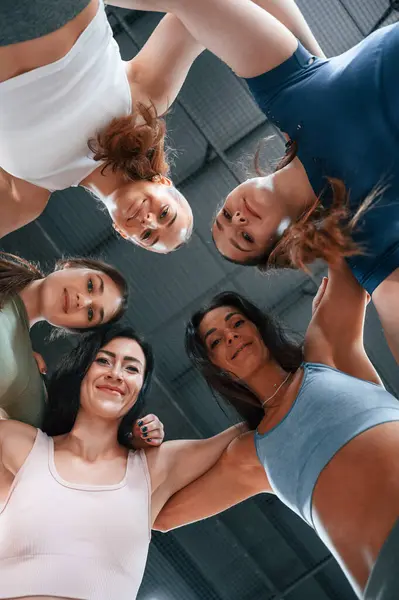 stock image View from below. Conception of unity. Group of women practicing fitness in the gym.