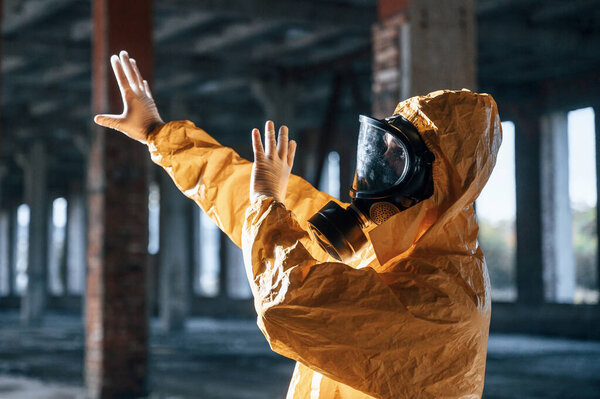 Nuclear explosion. Man dressed in chemical protection suit in the ruins of the post apocalyptic building.