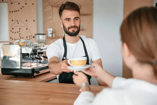 stock image Customer takes her order from barista in the cafe.