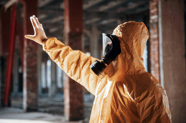 Nuclear explosion. Man dressed in chemical protection suit in the ruins of the post apocalyptic building.