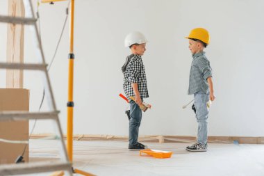 Neşeli çocuklar. İki çocuk ev odasında duvar boyuyor..