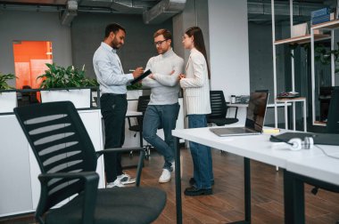 In the modern office. Couple are getting consulted by a manager. clipart