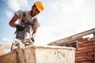 Betonu karıştırıyor. Yakışıklı Hintli adam şantiyede..