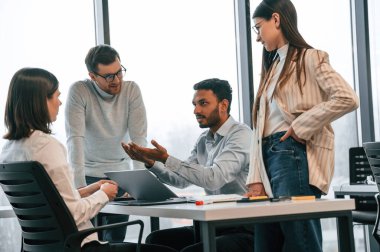 Beyin fırtınası kavramı. Ofiste birlikte çalışan dört kişi var..