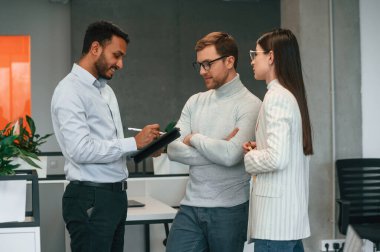 Standing and talking. Couple are in the office, getting consulted by a manager. clipart