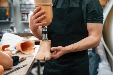 Manzarayı kapat. Elinde protez tutan teknisyen..