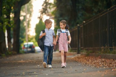 Ön manzara, birlikte yürümek. Erkek ve kız çocukları dışarıda..