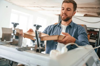 Teknisyen çalışıyor. Yakışıklı adam ekolojik kutular üreten fabrikada..