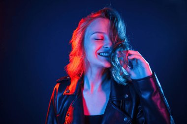 Olumlu yüz ifadesi. Neon renkli güzel bir kadın portresi..