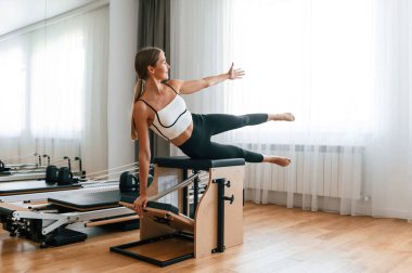 Bacağımdan. Spor salonundaki genç kadın egzersiz yapıyor..