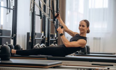 Spor seansı. Genç bayan antrenman malzemeleriyle spor salonunda..