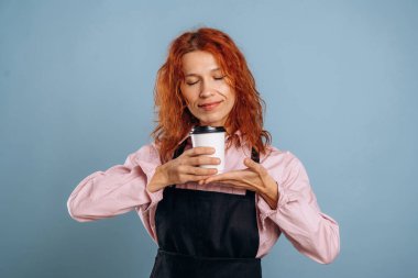 Beyaz kağıt bardakta taze içecek. Kadın stüdyoda arka planda..