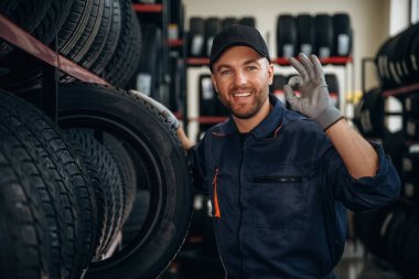 Dost canlısı yüz ifadesi, şapkalı. Tekerlekleri ve tekerlekleri olan tamirci var..