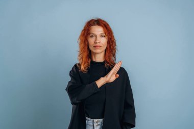 İşaret dili, harfleri gösteriyor. Kadın stüdyoda arka planda..