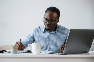 Müdür dizüstü bilgisayar kullanıyor. İşadamı ofiste çalışıyor..