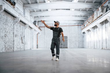 Büyük bir alan. Erkek işçi boş depoda..